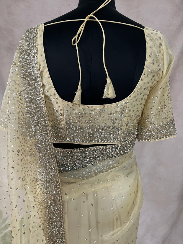 Soft Organza Light Yellow color saree with sequins work and stitched blouse
