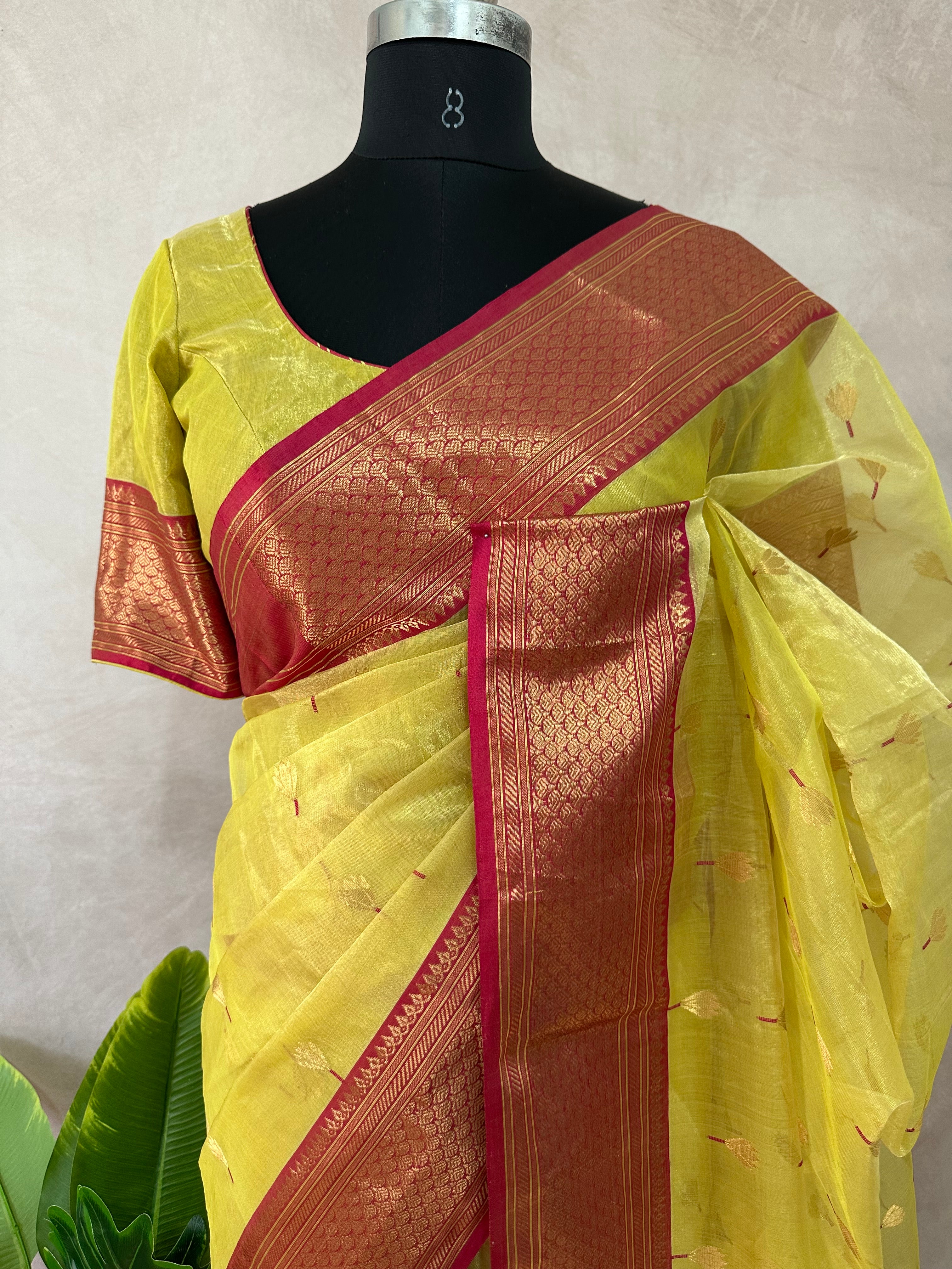 Yellow tissue chanderi saree with pink broder, comes with stitched blouse and under skirt