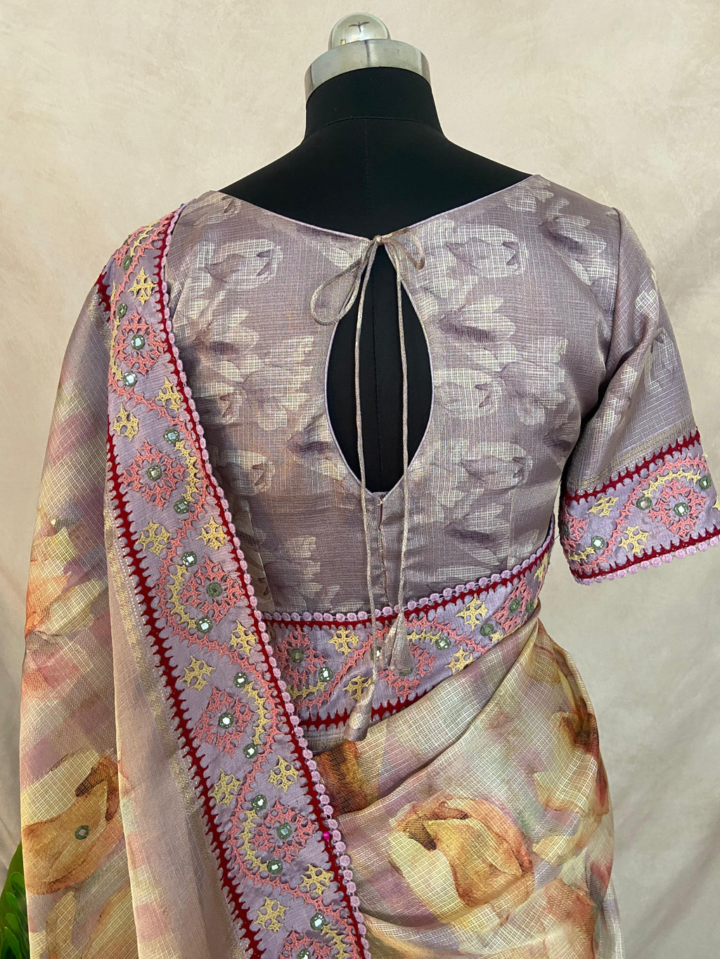 Tissue kotta saree with kutch work border and stitched blouse