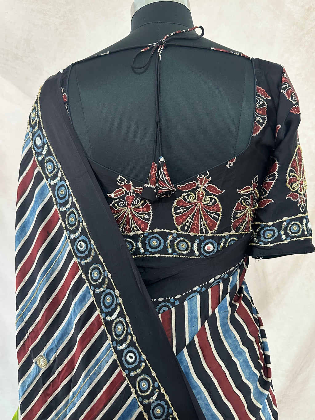Designer Ajrakh modal silk saree with bead and mirroer handwork, stitched blouse