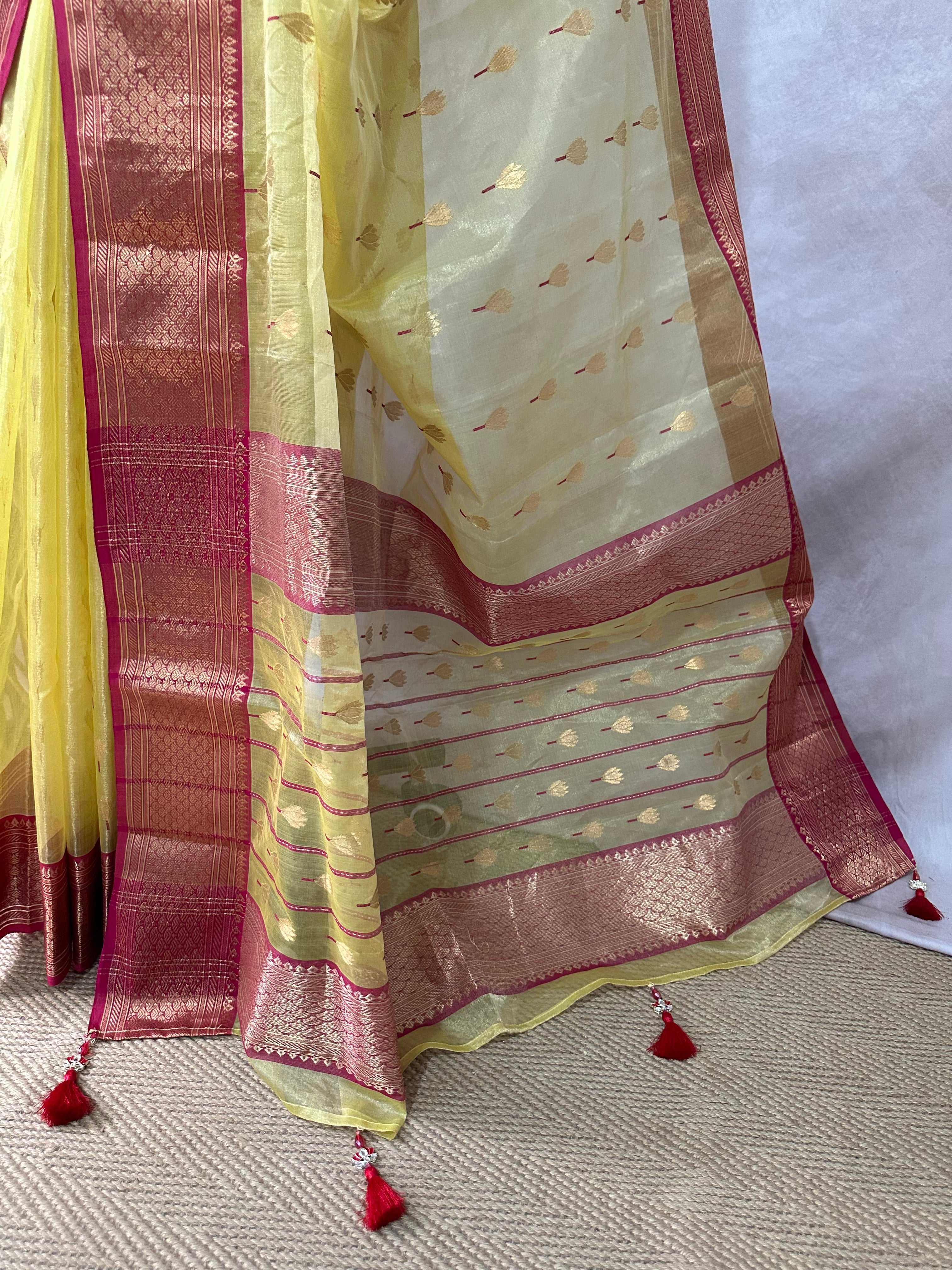 Yellow tissue chanderi saree with pink broder, comes with stitched blouse and under skirt