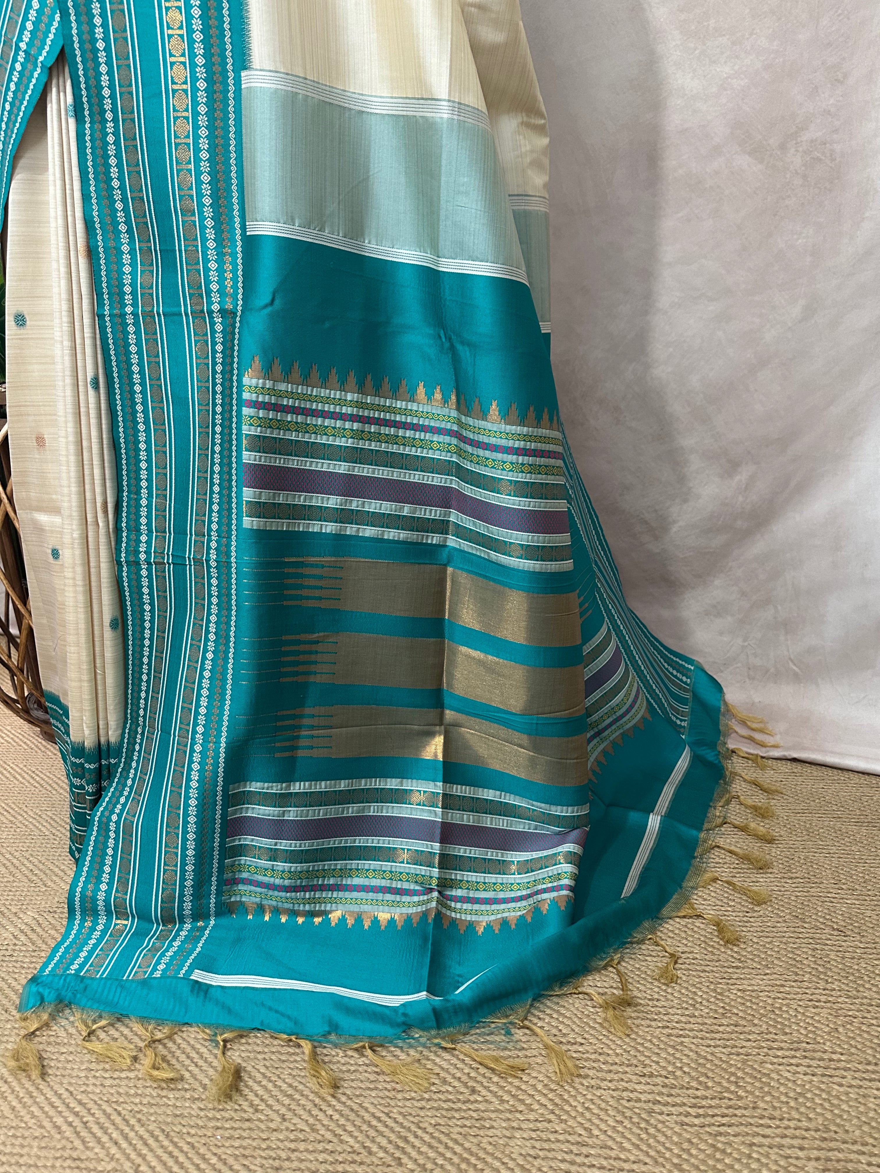 Asam silk saree with Turquoise green broder and stitched blouse