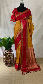 Mustard yellow and red Kanchivaram saree with stitched blouse