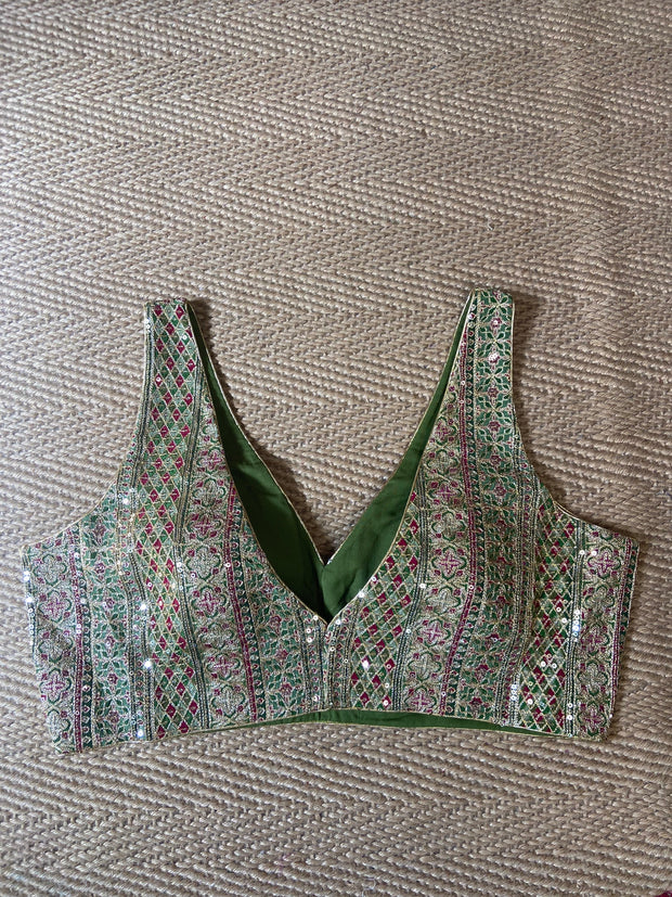 Green sleeveless blouse