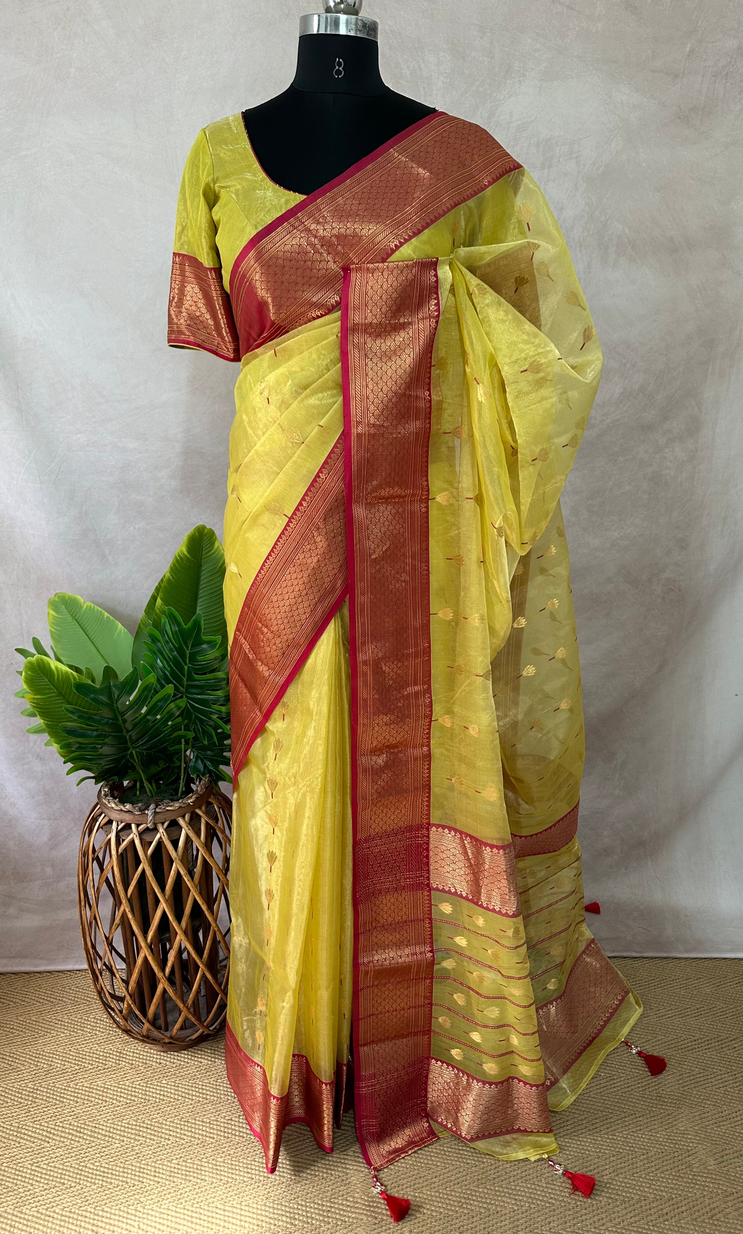 Yellow tissue chanderi saree with pink broder, comes with stitched blouse and under skirt