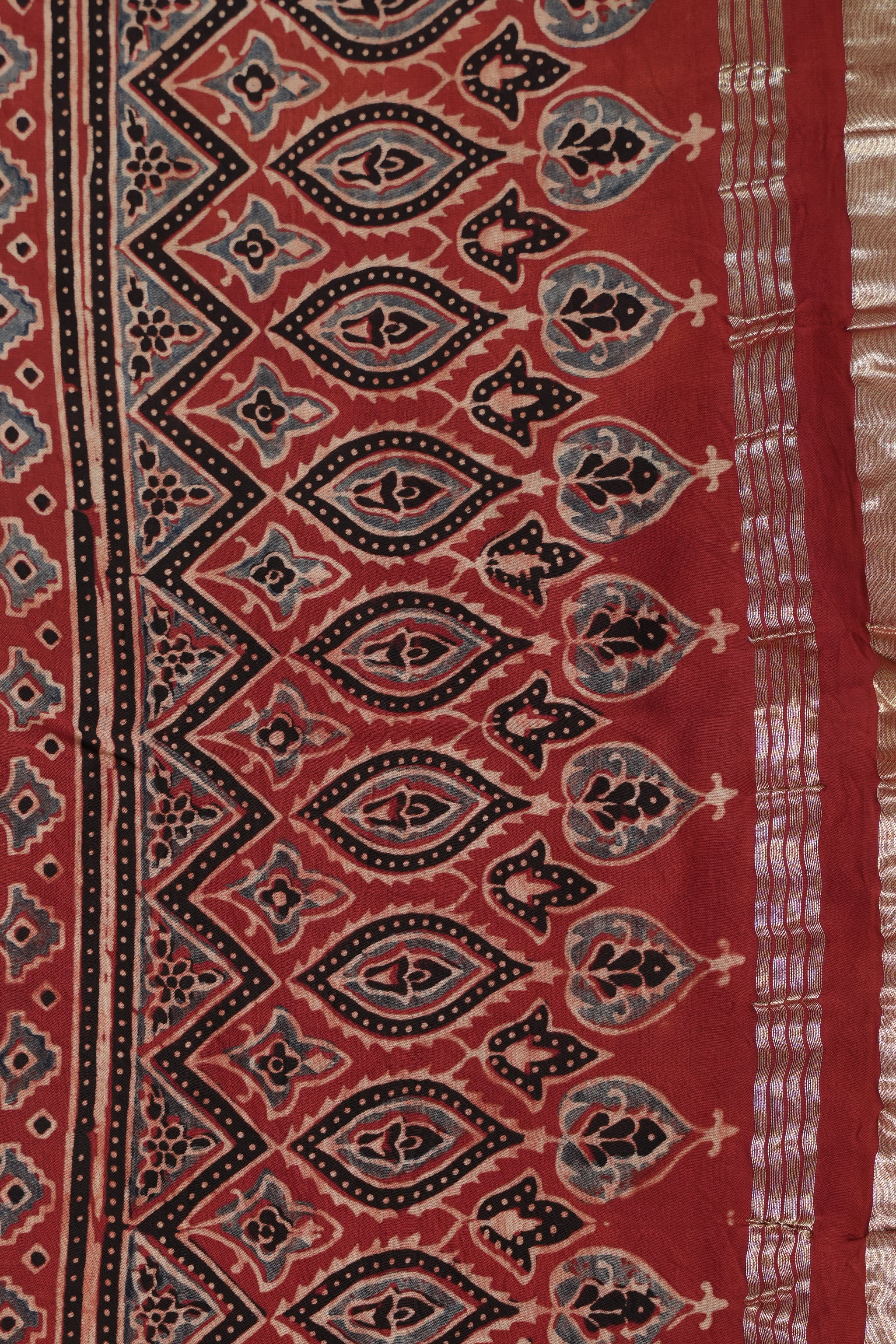 Hand block Ajrakh print Red modal silk saree with gotta patti border, with stitched blouse