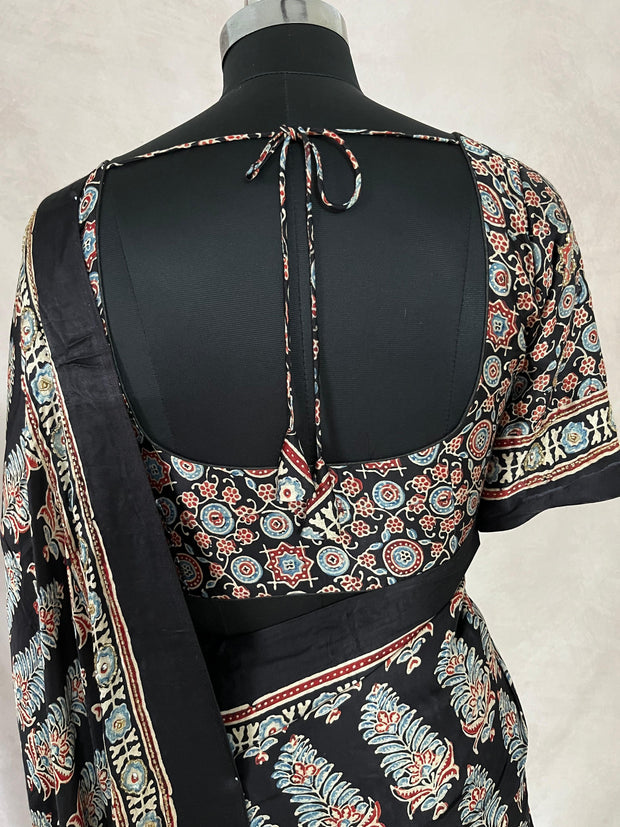 Black modal silk saree with hand work and stitched blouse