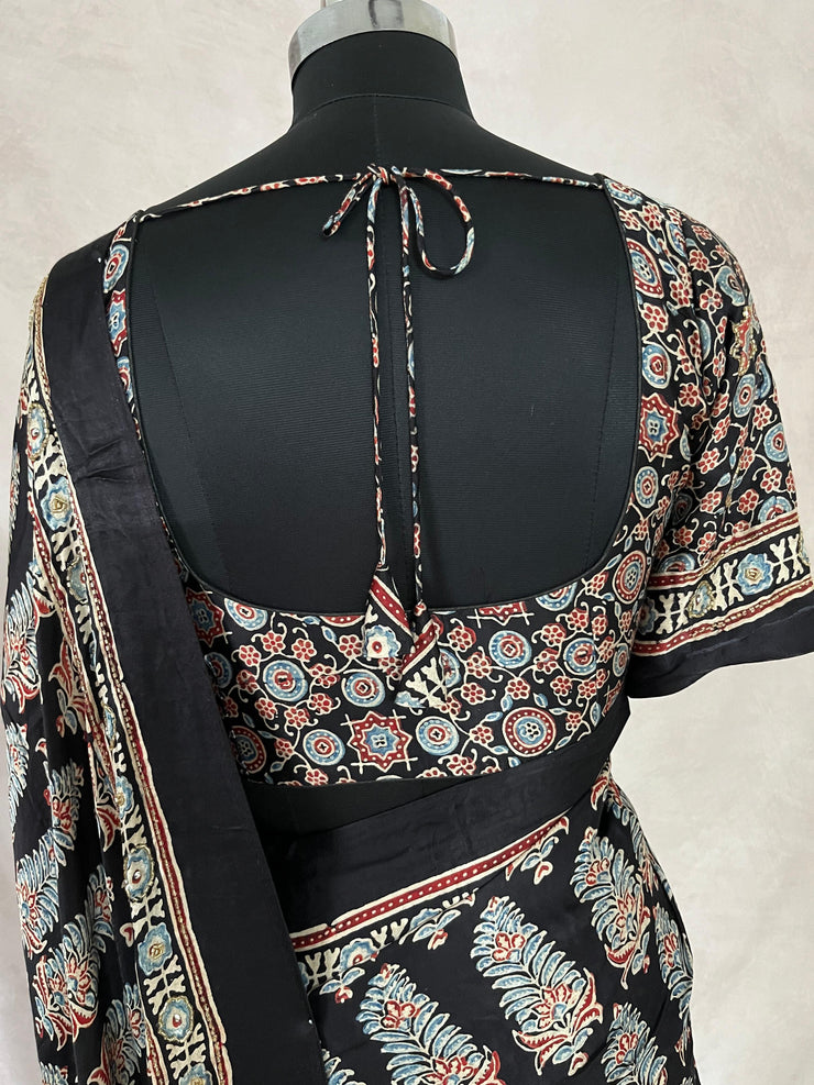 Black modal silk saree with hand work and stitched blouse