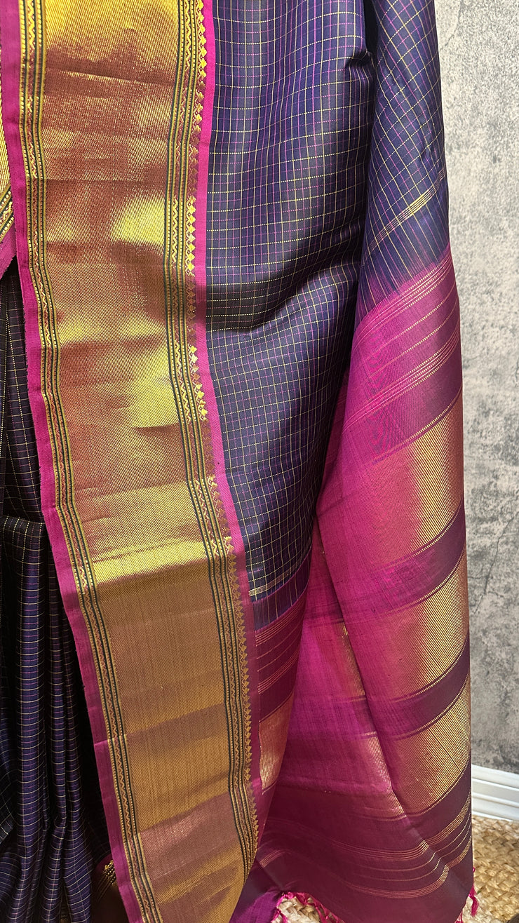 Navy blue Kanchivaram saree with purple border, with stitched blouse