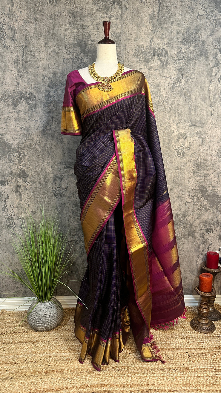 Navy blue Kanchivaram saree with purple border, with stitched blouse
