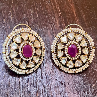 moissanite stud with a magenta stone
