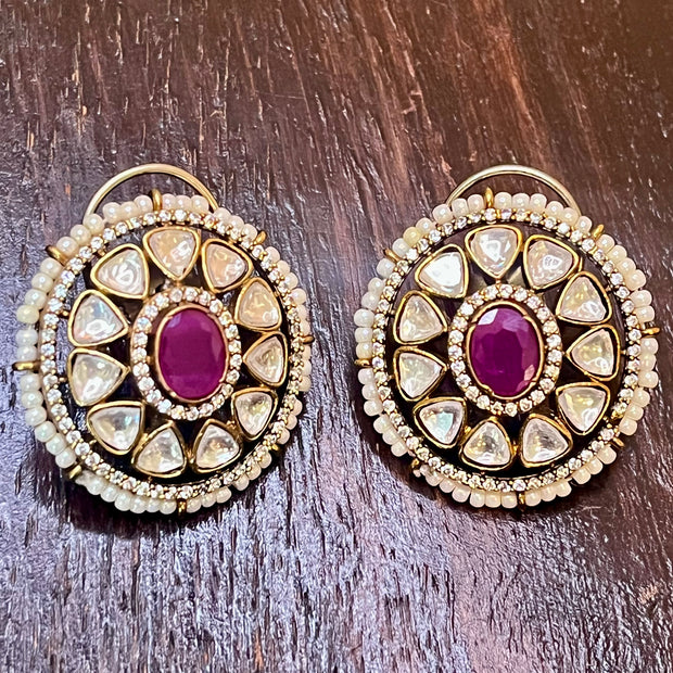 moissanite stud with a magenta stone