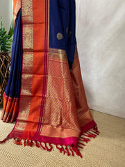 Blue Kanchivaram saree with pink and orange border, and stitched blouse