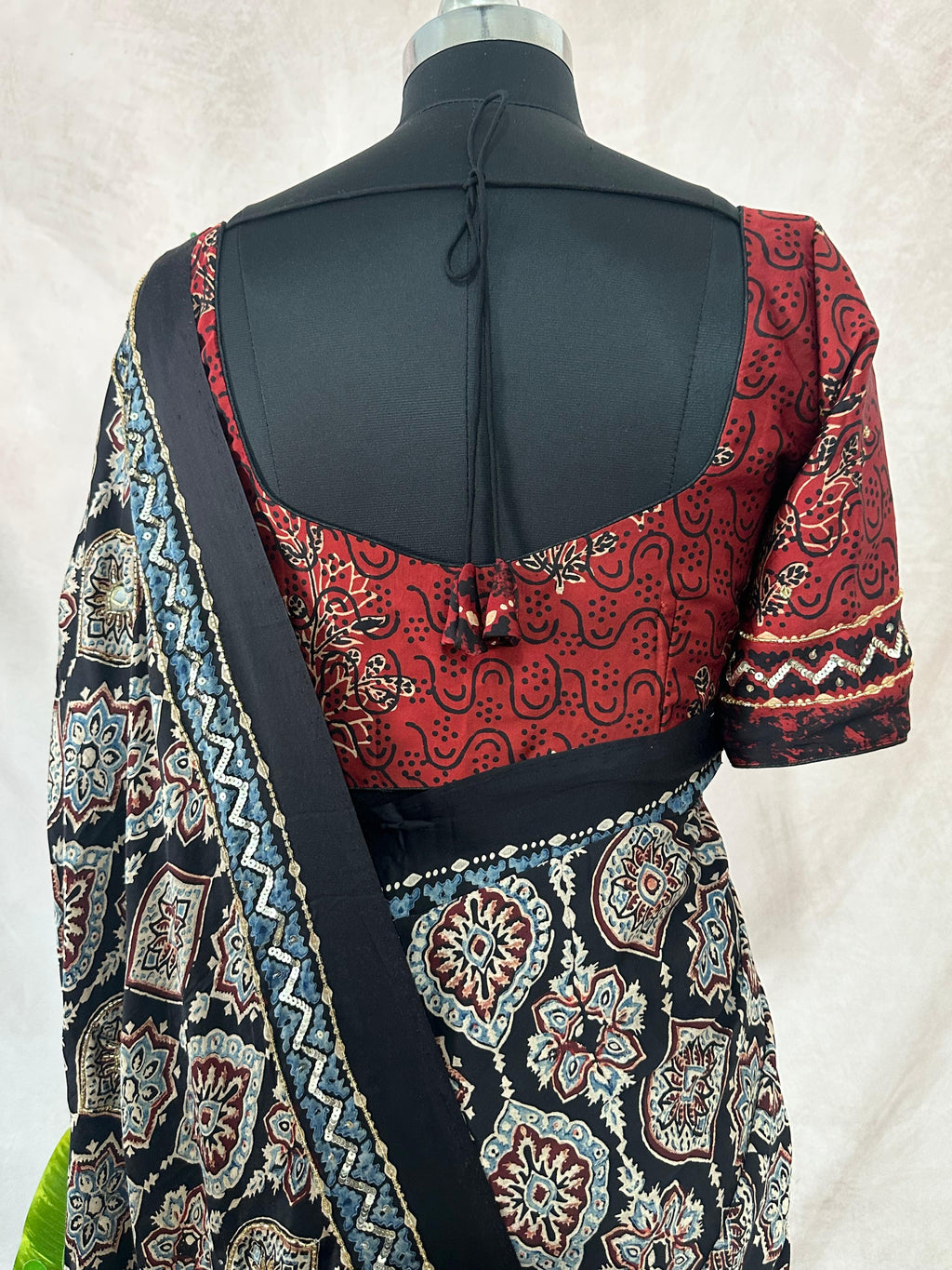 Designer Ajrakh modal silk saree with bead and mirroer handwork, stitched blouse