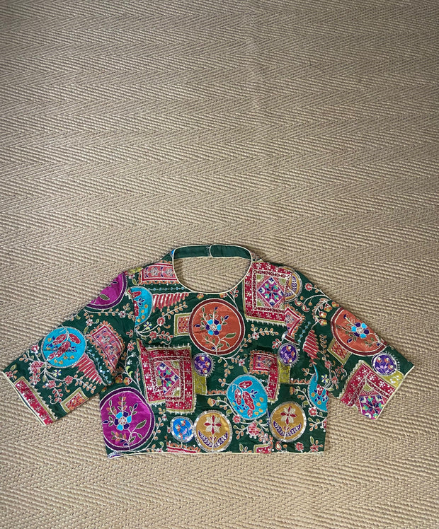 Green blouse with multi color print and highlighted with threadwork