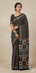 Designer Ajrakh modal silk saree with bead and mirror handwork, stitched blouse
