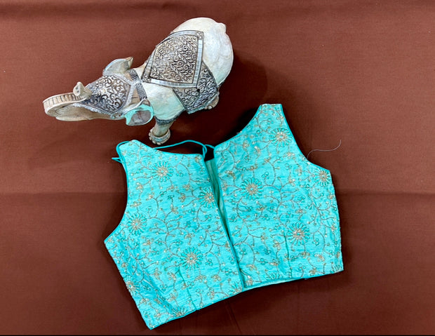 Light blue semi silk sleeveless blouse with emroidery