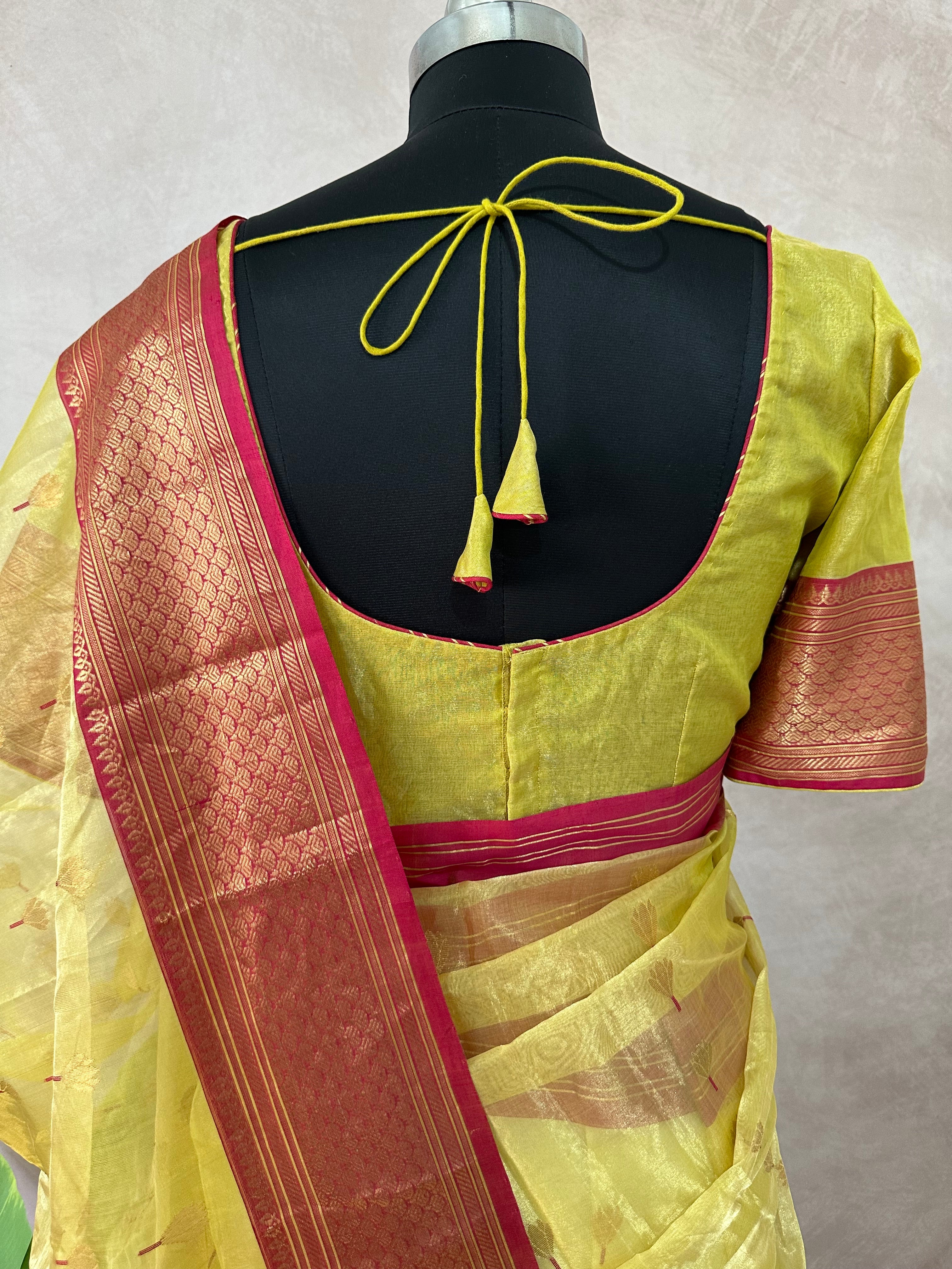 Yellow tissue chanderi saree with pink broder, comes with stitched blouse and under skirt