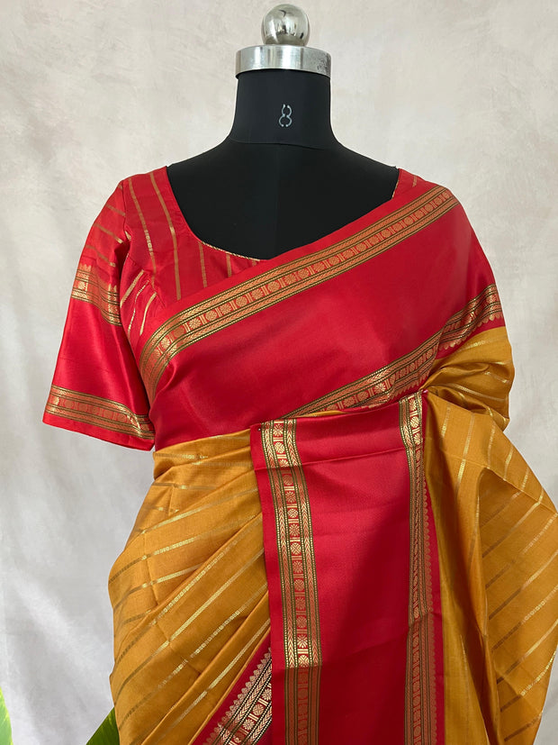 Mustard yellow and red Kanchivaram saree with stitched blouse
