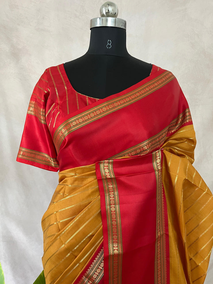 Mustard yellow and red Kanchivaram saree with stitched blouse