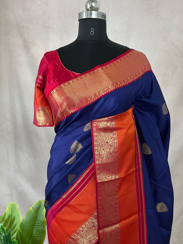 Blue Kanchivaram saree with pink and orange border, and stitched blouse