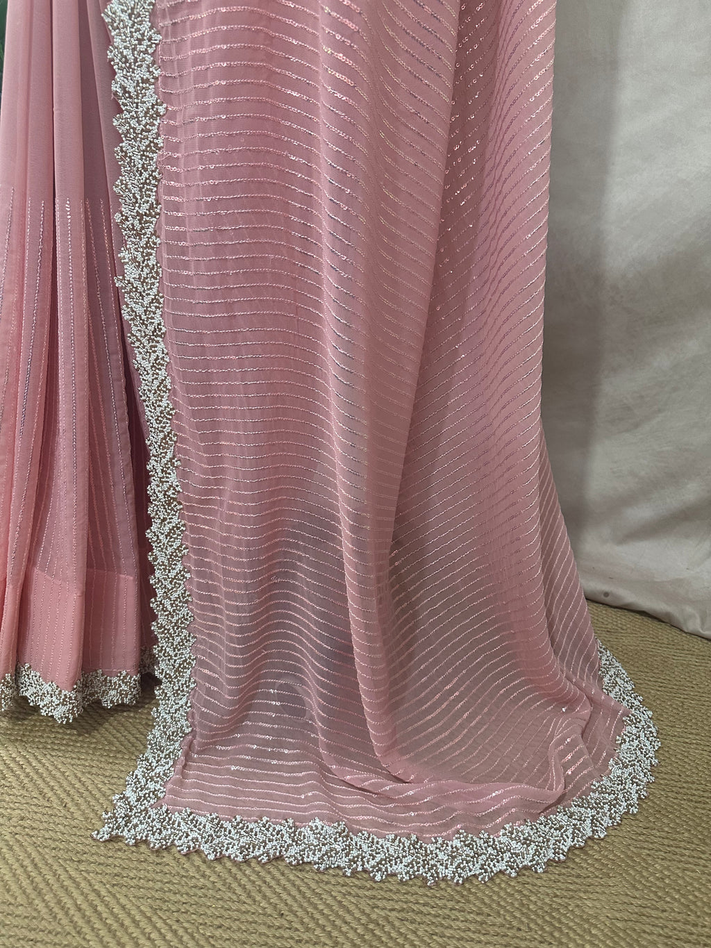 Light pink georgette saree with bead embroidery and stitched blouse