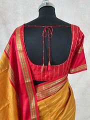 Mustard yellow and red Kanchivaram saree with stitched blouse
