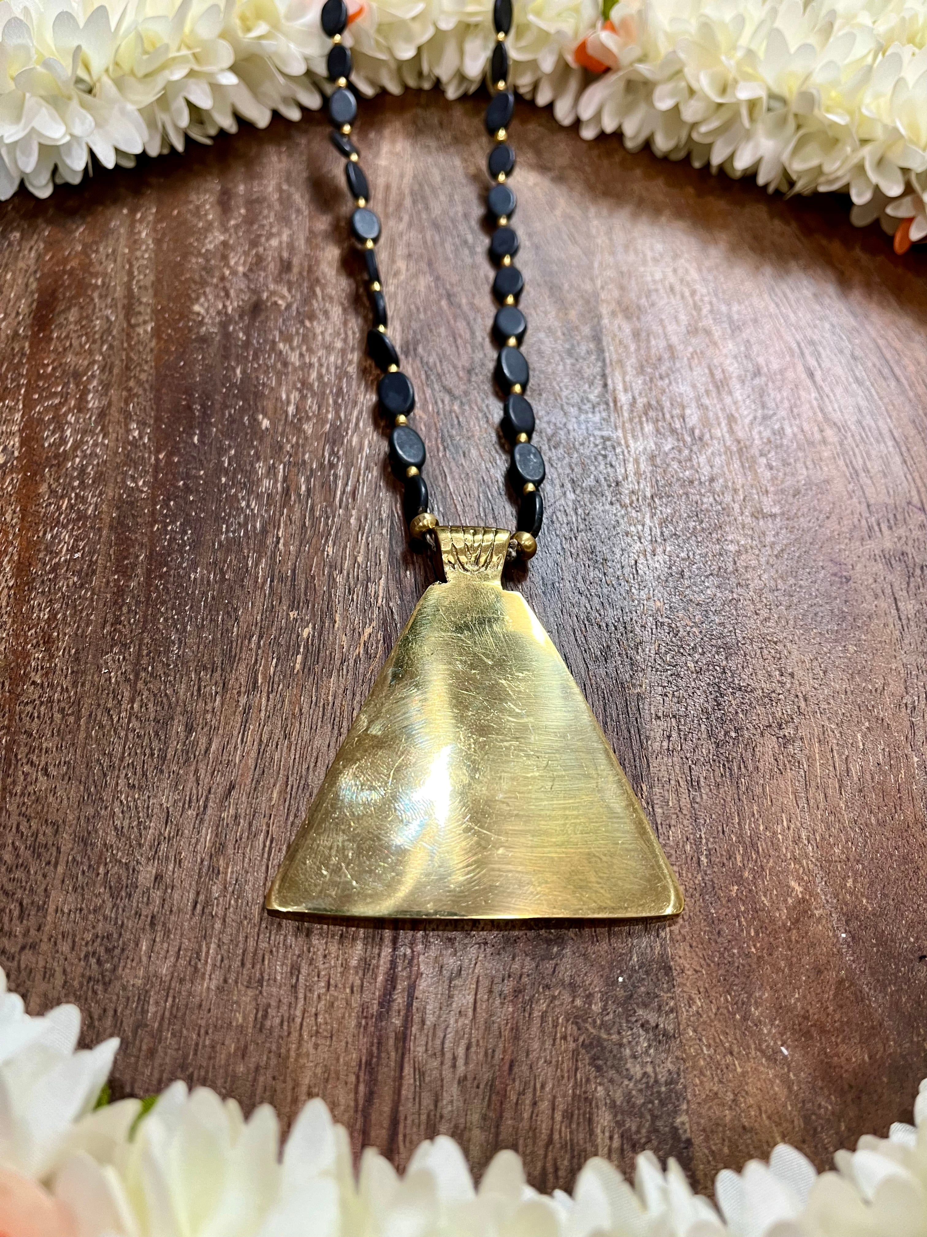 Gold tone pendant with black beads