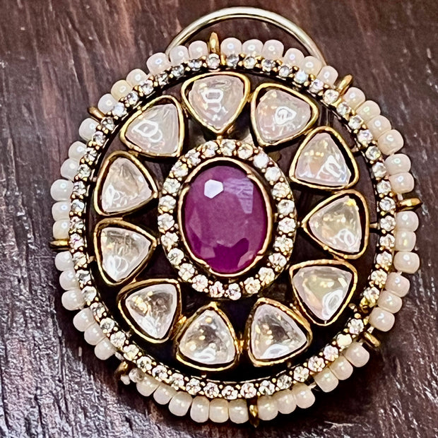 moissanite stud with a magenta stone