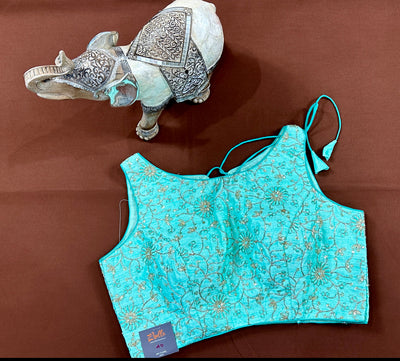 Light blue semi silk sleeveless blouse with emroidery