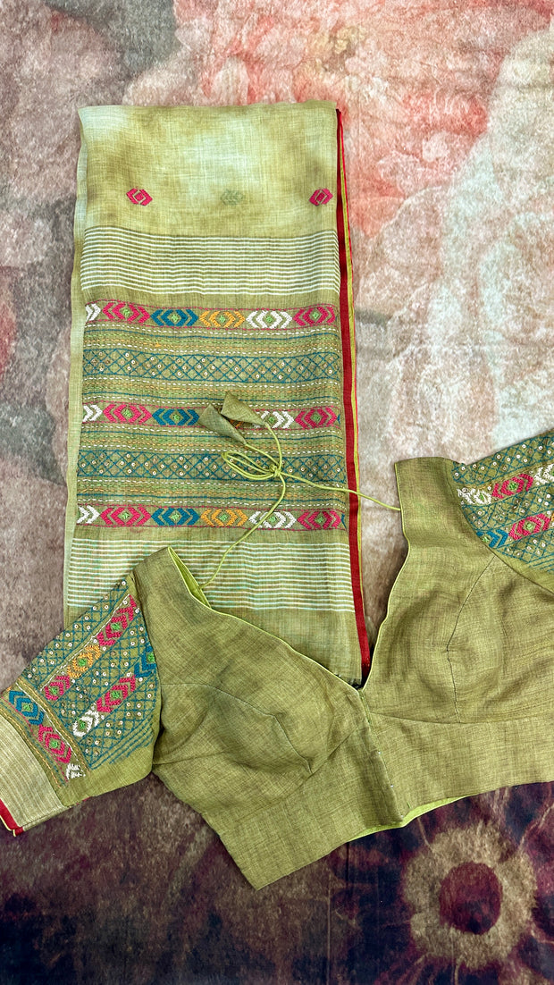 Olive green linen saree with hand embroidery , stitched blouse