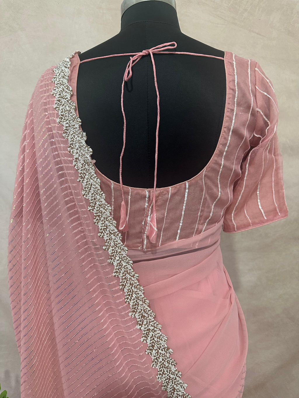 Light pink georgette saree with bead embroidery and stitched blouse