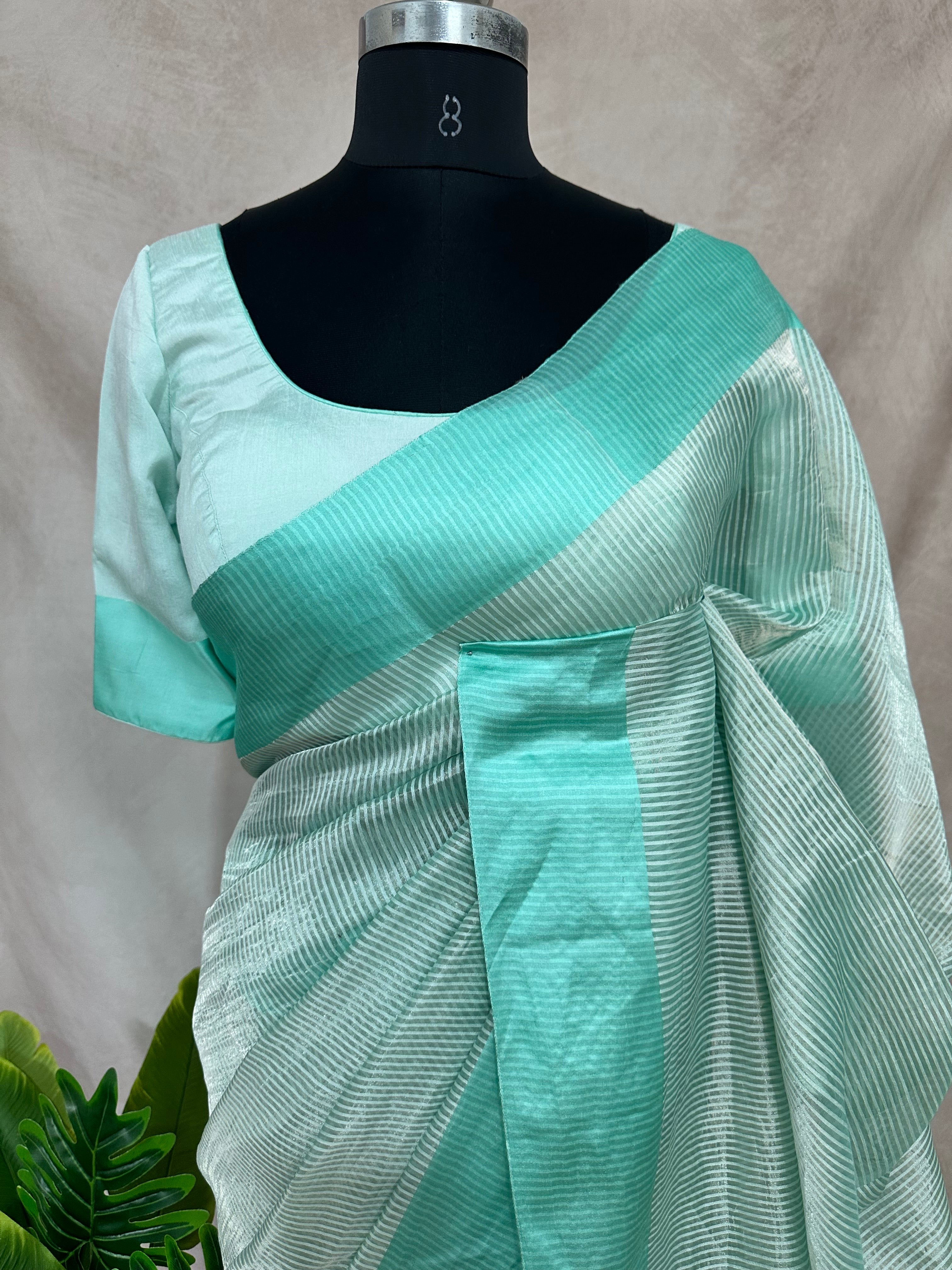 Light pista green stripe tissue silk saree with stitched blouse