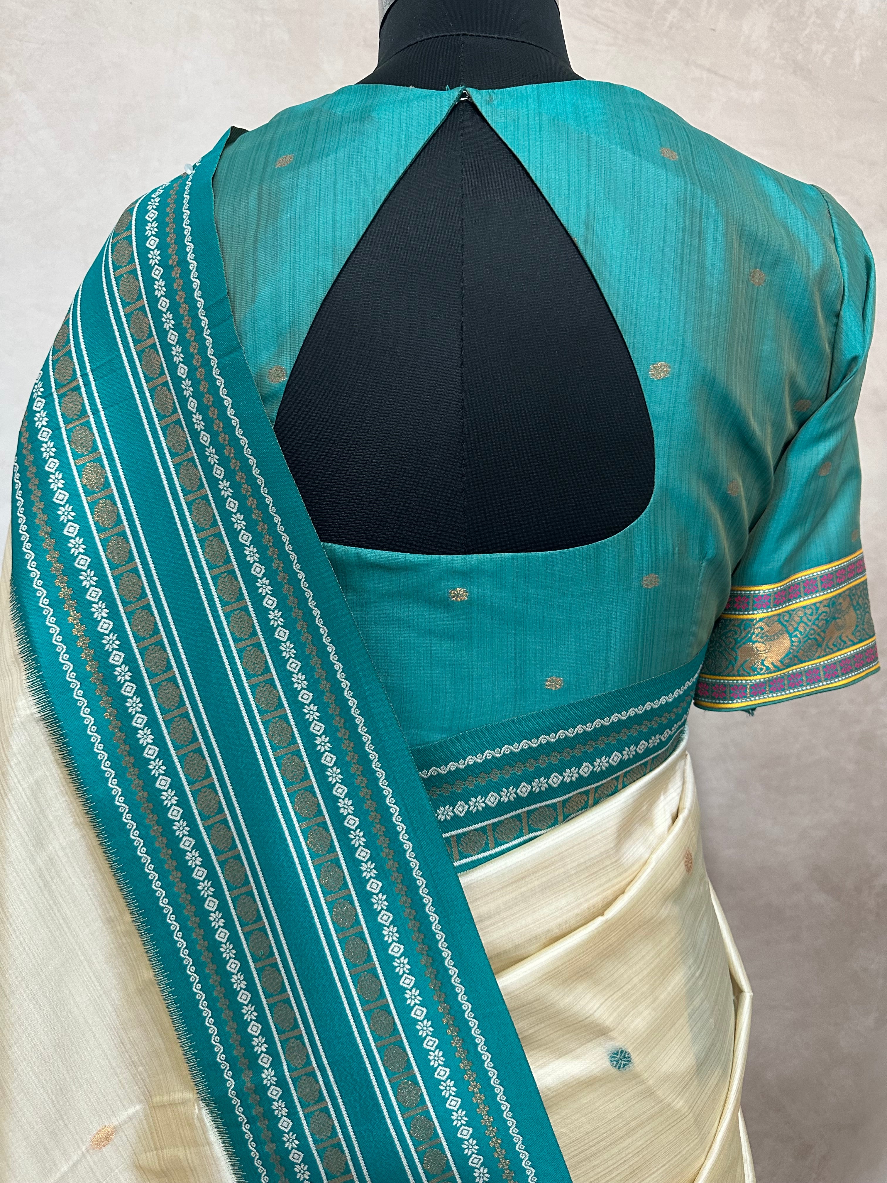 Asam silk saree with Turquoise green broder and stitched blouse