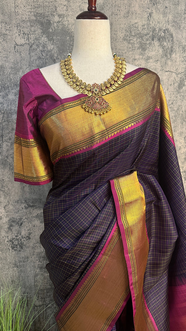 Navy blue Kanchivaram saree with purple border, with stitched blouse