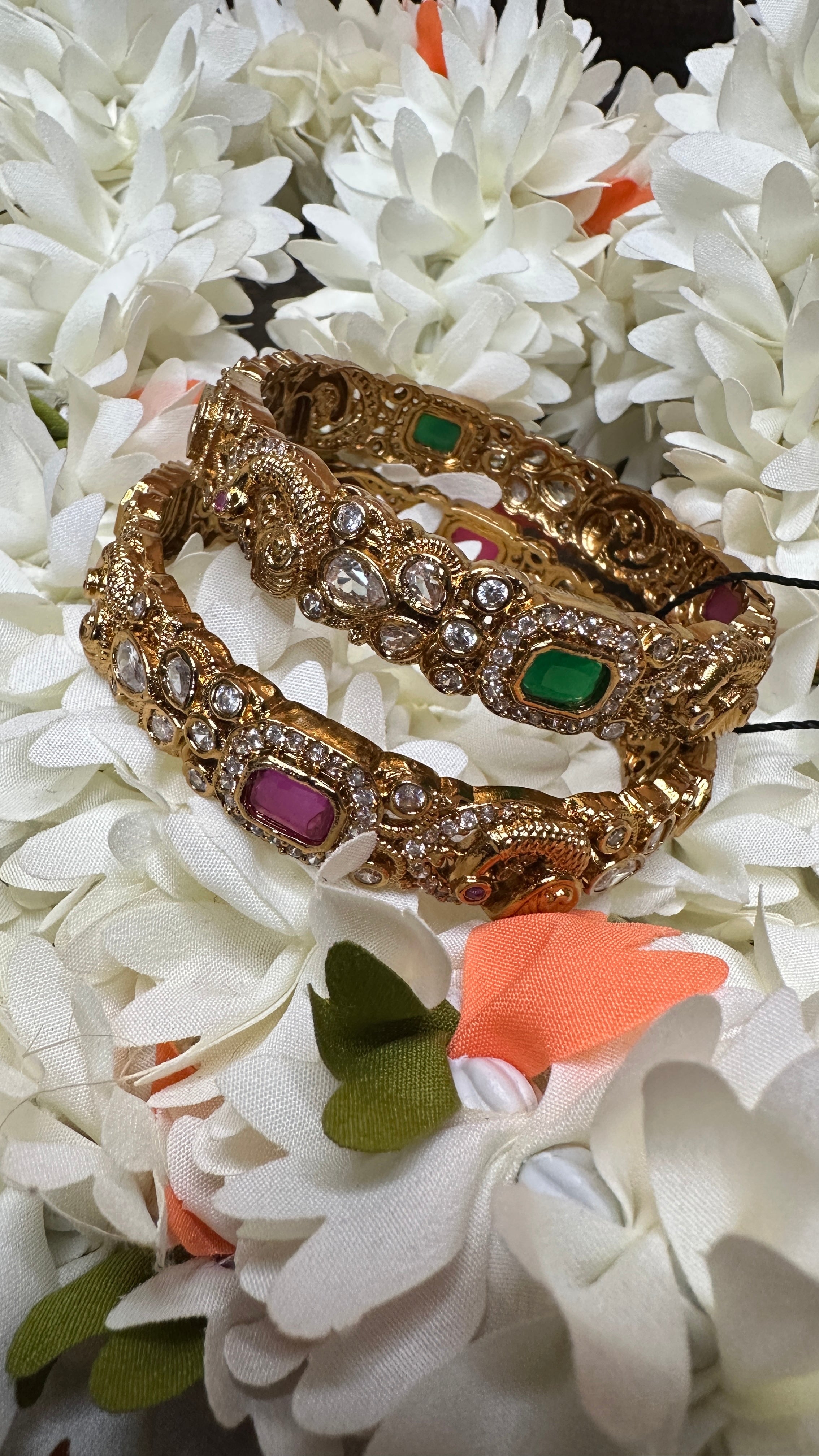Gold bangles with white, green and ruby red stones set /size - 2.4