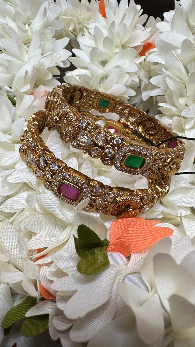 Gold bangles with white, green and ruby red stones set /size - 2.4