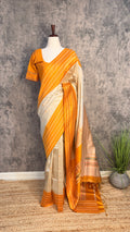 Asam silk saree with green border and stitched blouse