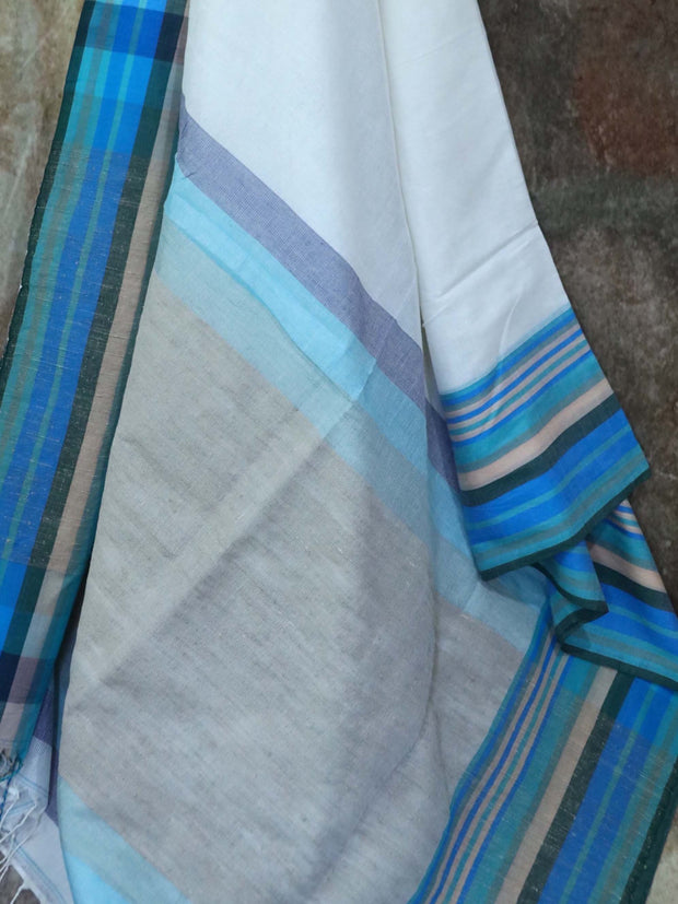 Offwhite cotton saree, with sleeveless designer blouse with embroidery.