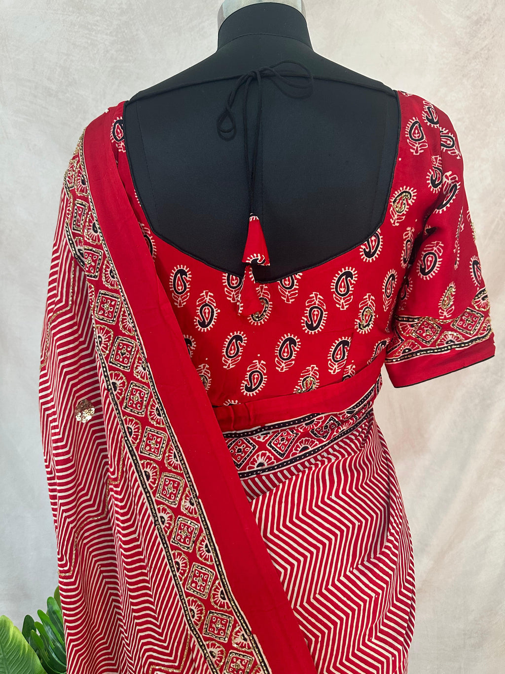 Designer Ajrakh modal silk saree with bead and mirror handwork, stitched blouse