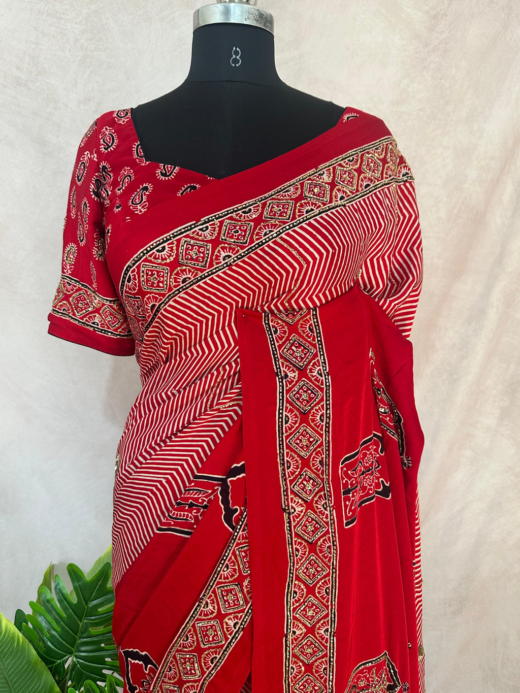 Designer Ajrakh modal silk saree with bead and mirror handwork, stitched blouse