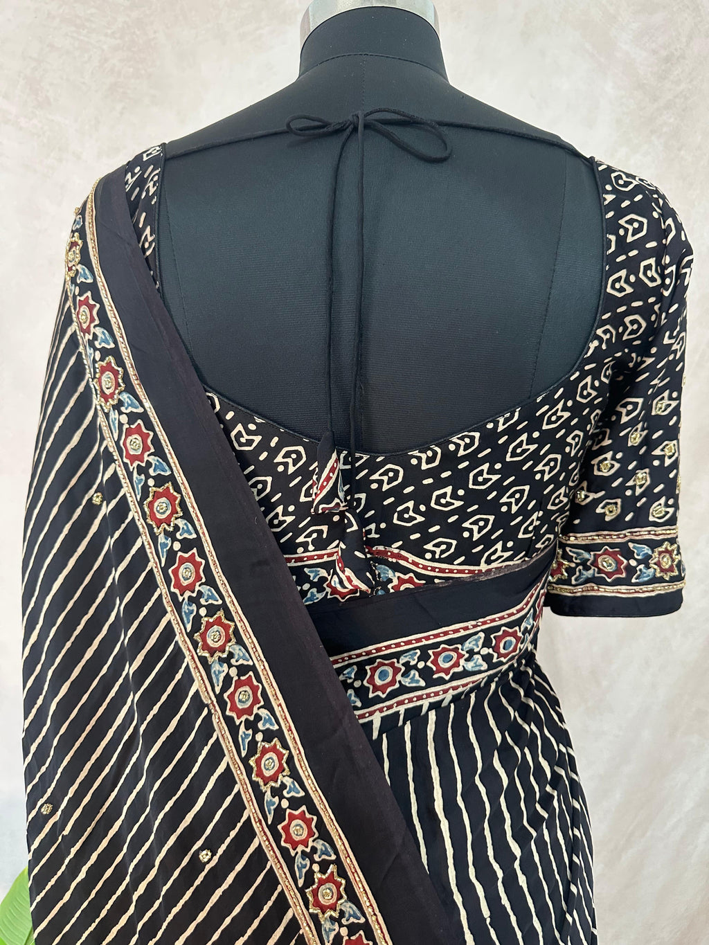 Designer Ajrakh modal silk saree with bead and mirror handwork, stitched blouse