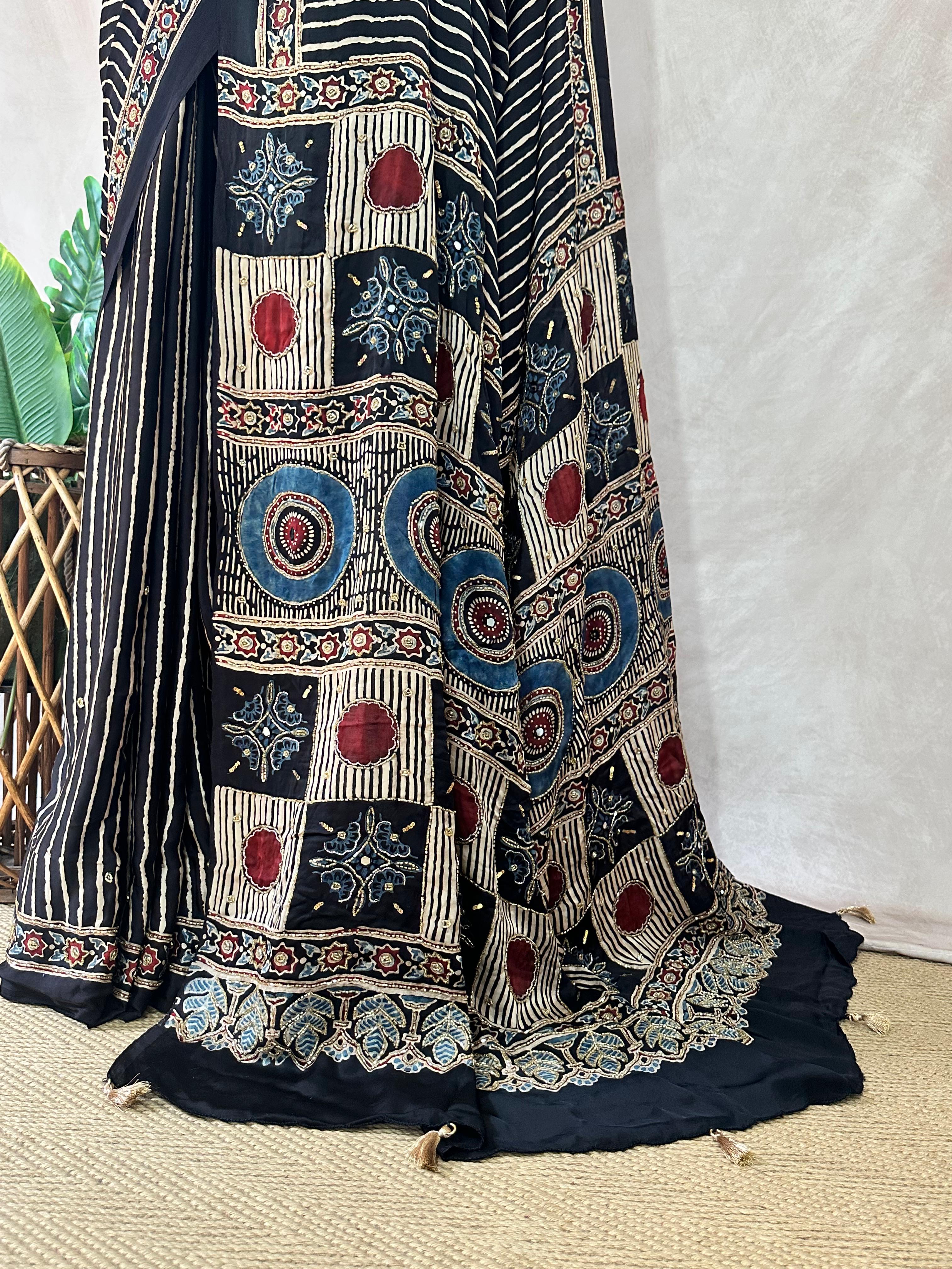 Designer Ajrakh modal silk saree with bead and mirror handwork, stitched blouse