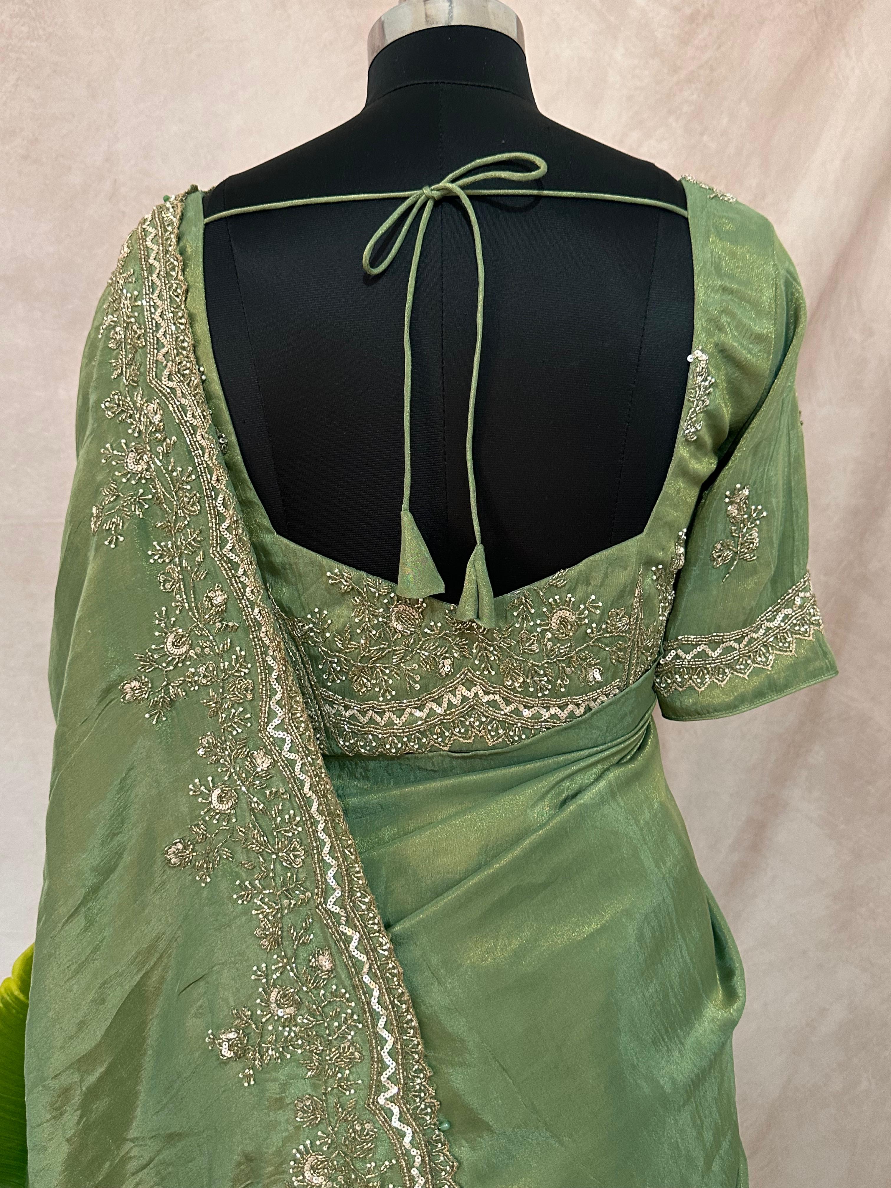 Green tissue designer saree with stitched blouse and under skirt