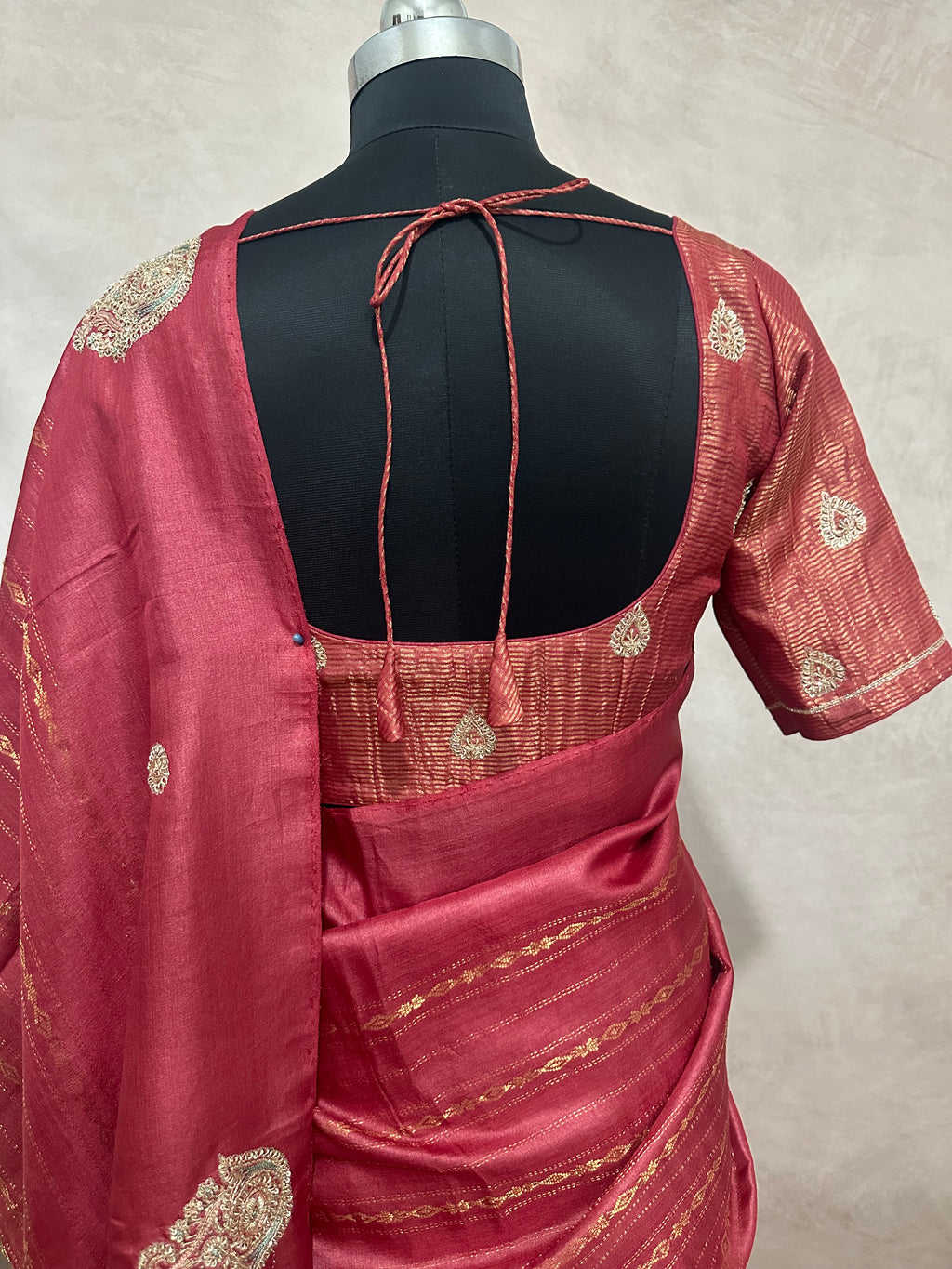 Coral color pure tussar silk saree with hand work and stitched blouse