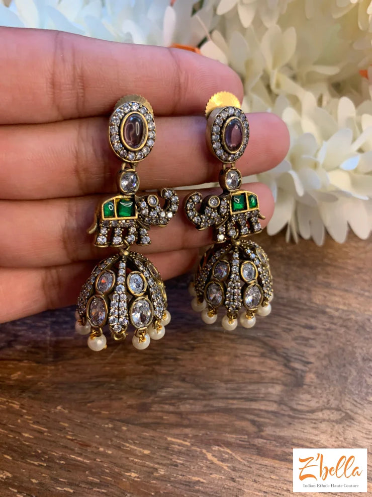 Victorian Finish Jhumka With Kundan And Green Stone Earrings Gold Tone